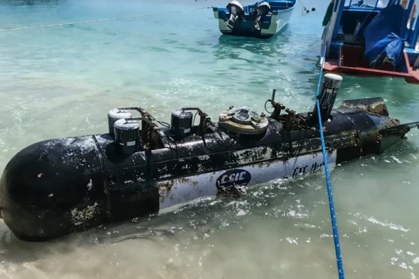 A picture taken on April 6, 2026, shows a torpedo-like 3.7-metre-long and 65-centimetre-wide object, discovered by a fisherman near the Lombok Strait after being towed ashore onto a beach on Gili Trawangan, West Nusa Tenggara. The Indonesian navy said on April 9, it was investigating a torpedo-like object discovered by a fisherman near the Lombok Strait, a key maritime route connecting the Indian and Pacific Oceans. (Photo by AFP)
