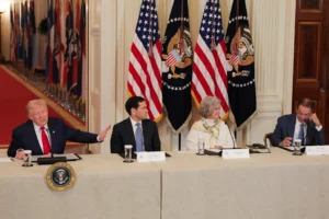 WASHINGTON, DC - MARCH 06: U.S. President Donald Trump (L) gestures as former head coach Nick Saban (R) speaks alongside U.S. Secretary of State Marco Rubio and White House Chief of Staff Susie Wiles during a roundtable discussion on college sports in the East Room of the White House on March 06, 2026 in Washington, DC. The Trump administration held the roundtable titled "Saving College Sports" with leaders from the Power Four conferences, media executives and former coaches. (Photo by Anna Moneymaker/Getty Images)