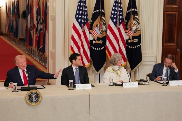 WASHINGTON, DC - MARCH 06: U.S. President Donald Trump (L) gestures as former head coach Nick Saban (R) speaks alongside U.S. Secretary of State Marco Rubio and White House Chief of Staff Susie Wiles during a roundtable discussion on college sports in the East Room of the White House on March 06, 2026 in Washington, DC. The Trump administration held the roundtable titled "Saving College Sports" with leaders from the Power Four conferences, media executives and former coaches. (Photo by Anna Moneymaker/Getty Images)