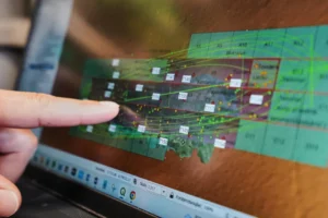 An archaeologist points to a computer screen showing a map of the wreck of Danish flagship