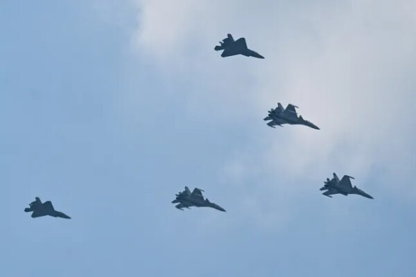 Shenyang J-15 (lead and middle aircraft) and Shenyang J-35 (back) jet fighters perform a flyby during a military parade marking the 80th anniversary of victory over Japan and the end of World War II, in Beijing's Tiananmen Square on September 3, 2025.