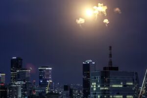TOPSHOT - Explosions from projectile interceptions by Israel's Iron Dome missile defence system are pictured over Tel Aviv on February 28, 2026. (AFP)