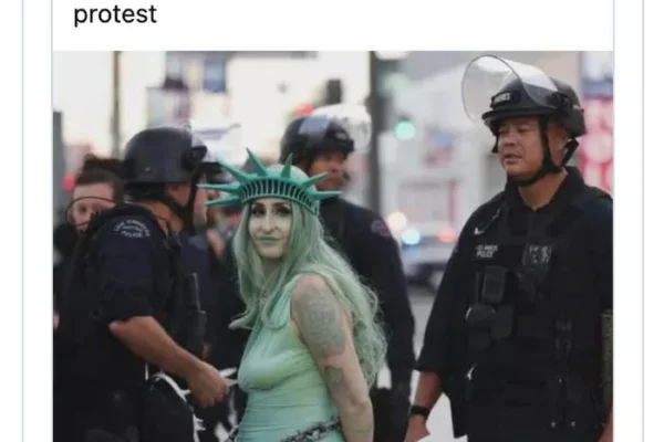 Tweet showing a meme of LAPD officers arresting a person dressed as the Statue of Liberty during a protest