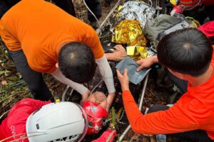 The rescue team attends to the 79-year-old hiker before airlifting him to hospital. Photo: Handout