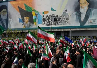 Mourners carry Iranian flags in Tehran on April 1, 2026 during a funeral procession for Alireza Tangsiri, head of Iran's Islamic Revolutionary Guard Corps Navy, and others killed in Israeli strikes (AP)