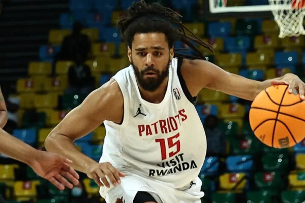 Jermaine Cole dribbling basketball during game at Kigali Arena