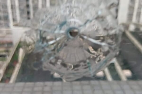A social media post shows airgun damage to a window of a flat at Shek Ping House. Photo: Threads/@ritachong628