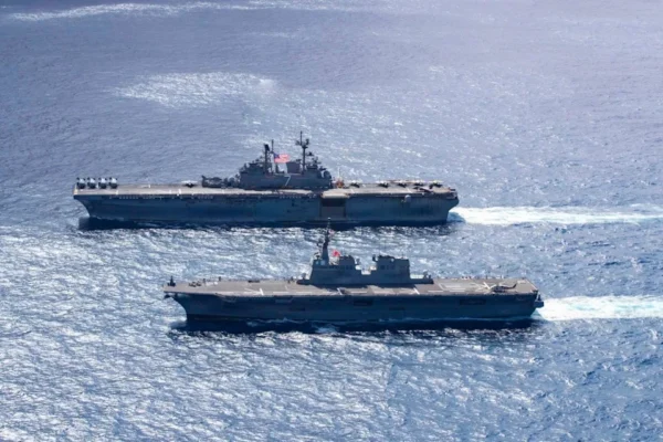 Japanese Hyūga-class helicopter destroyer JS Ise, bottom, sails alongside America-class amphibious assault ship USS Tripoli during exercise Iron Fist on March 1. (Japan Maritime Self-Defense Force)