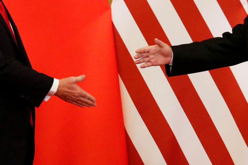 US President Donald Trump and China's leader Xi Jinping shake hands at the Great Hall of the People in Beijing, China, November 9, 2017.
