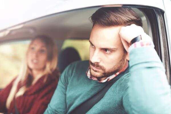 Frustrated car driver. Young couple having a problem with navigation during their journey with a car, missed road. Bad relationship, discussions between man and woman