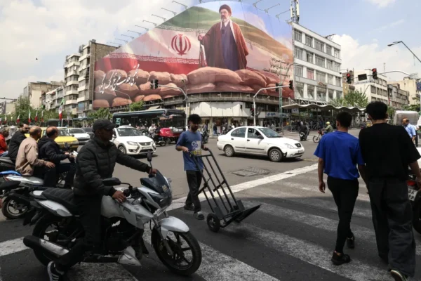 Commuters drive past a large billboard depicting Iran's Supreme Leader Ayatollah Mojtaba Khamenei on a street in Tehran on April 20, 2026. Iran insisted it has no plan to attend a new round of negotiations with the United States on April 20, as uncertainty grows over a push to stop the Middle East war from resuming. The US president said he was sending negotiators to Pakistan for talks on ending the war that engulfed the region and rattled global markets, while repeating threats to attack Iran's energy infrastructure if it did not make a deal.