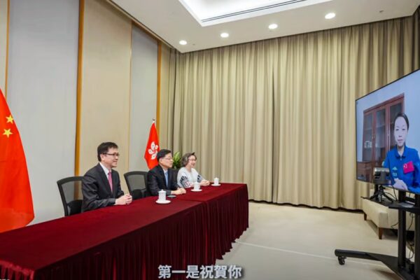 Chief Executive John Lee (second from left) holds a video call with payload specialist Lai ahead of the Shenzhou-23 mission. Photo: Handout