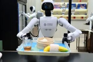 A picture taken on March 3, 2026 shows a robot serving food and drinks on China Mobile stand during the Mobile World Congress (MWC), the world's biggest mobile technology showcase and fair in Barcelona. (AFP FILE)