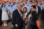 President Donald Trump talks during an arrival ceremony Wednesday, May 13, 2026, at Beijing Capital International Airport in Beijing, with Eric Trump, right.