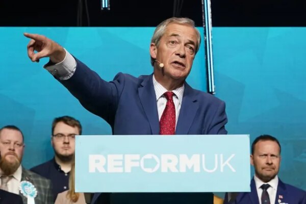 HULL, ENGLAND - MARCH 30: Leader of Reform UK Nigel Farage gestures as he speaks onstage during a Reform UK campaign rally at Connexin Live on March 30, 2026 in Hull, England. Reform UK leading Nigel Farage is giving the keynote speech at the rally in Hull as the party campaigns ahead of local elections, scheduled to take place on May 7. (Photo by Ian Forsyth/Getty Images)