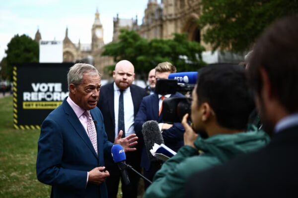 Reform UK leader Nigel Farage talks to members of the media during a photo call at College Green, Westminster. Photograph:  Henry Nicholls/AFP/Getty Images