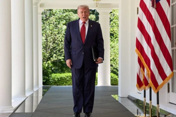 President Donald Trump walks through the Colonnade of the White House.