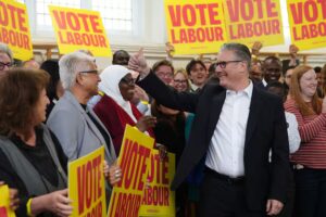 Britain's Prime Minister Keir Starmer gestures to supporters during a visit to All Saints Hall in south London, Tuesday May 5, 2026, whilst campaigning for the upcoming local elections