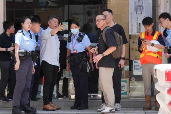 Police, Labour Department and Drainage Services Department officers investigating the accident at the Yen Chow Street site in Sham Shui Po. Photo: Jelly Tse