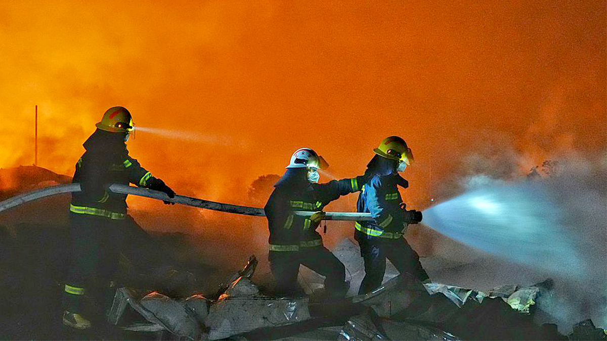 Fire crews work to put out a fire
