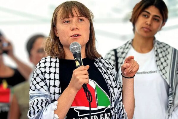 Climate activist Greta Thunberg speaking at a pro-Palestinian event in Italy while wearing a keffiyeh scarf.