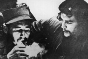 Fidel Castro lights a cigar while Argentine revolutionary Ernesto ‘Che’ Guevara looks on in the early days of their guerrilla campaign in Cuba’s Sierra Maestra mountains.