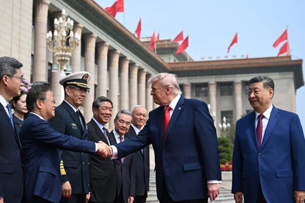 President Donald Trump and Chinese President Xi Jinping greeting officials at the Great Hall of the People