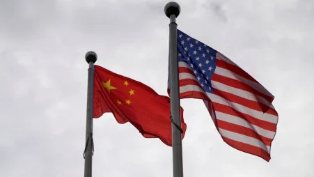 Chinese and US flags flutter outside a company building in Shanghai, China 16 November, 2021. REUTERS/Aly Song/File Photo