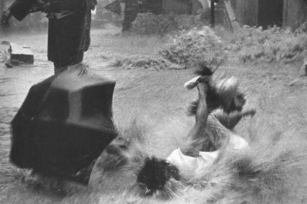 A woman falls into the floodwaters at the junction of Third and Centre Street in Sai Ying Pun under heavy rainstorms spread across Hong Kong in June 1966. Photo: Chan Kiu