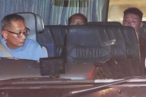Tsang Wai-bong (Centre) and Kwan Pui-sin (not pictured) were escorted to the Immigration Department to assist with the investigation. Photo: Edmond So