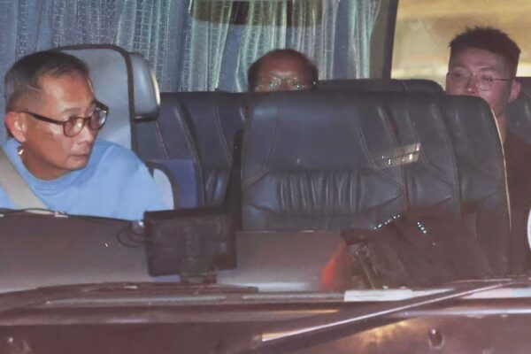 Tsang Wai-bong (Centre) and Kwan Pui-sin (not pictured) were escorted to the Immigration Department to assist with the investigation. Photo: Edmond So
