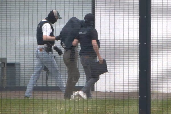 A man believed to be a suspected Chinese spy is taken to the Federal Court of Justice to be presented for arrest in Karlsruhe, Germany, on 20 May 2026.