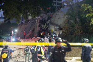 Rescue workers search for survivor at a collapsed building after...