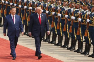 Donald Trump walks alongside Xi Jinping during a welcome ceremony at the Great Hall of the People.
