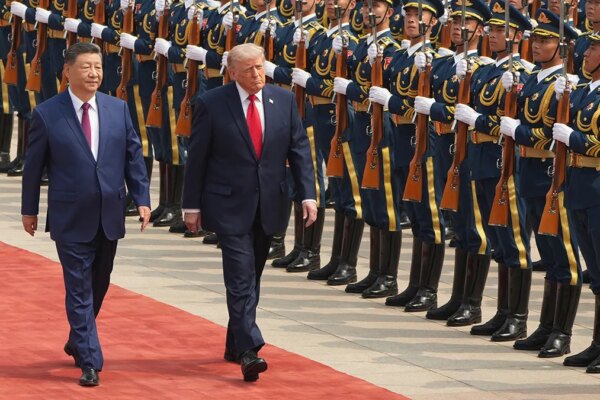 Donald Trump walks alongside Xi Jinping during a welcome ceremony at the Great Hall of the People.
