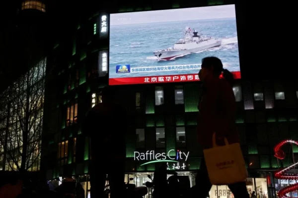 A Chinese navy vessel is seen on a news report about Chinese military drills around Taiwan in Beijing, China, April 1, 2025. - Florence Lo/Reuters