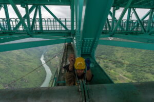 A worker tightens bolts on a pipe of the Huajiang Grand Canyon Bridge, considered to be the world’s highest bridge, in Anshun in southwestern China's Guizhou province on Friday, May 29, 2026. (AP Photo/Ng Han Guan)