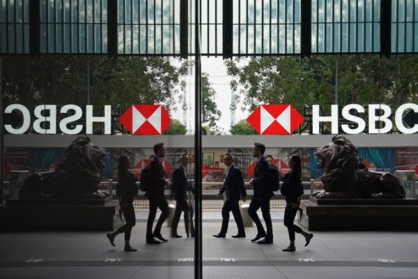 Pedestrians walk past HSBC’s head office in Central. Photo: Elson Li