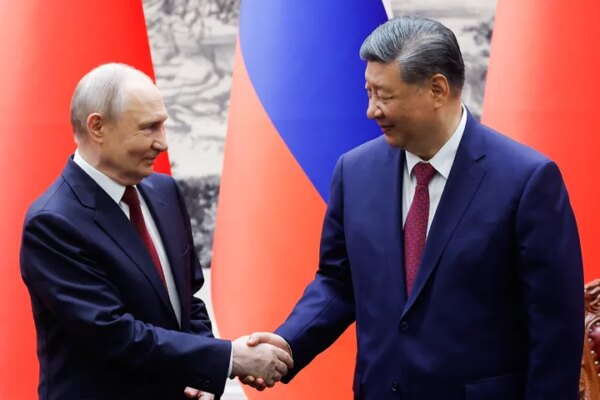 Russian President Vladimir Putin, left, and Chinese President Xi Jinping shake hands during a signing ceremony at the Great Hall of the People in Beijing, on May 20, 2026.