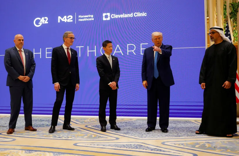 US President Donald Trump speaks next to Crown Prince of Abu Dhabi Sheikh Khaled bin Mohamed bin Zayed Al Nahyan, CEO of Cleveland Clinic Tom Mihaljevic and CEO of G42 Peng Xiao as he attends a business forum at Qasr Al Watan during the final stop of his Gulf visit, in Abu Dhabi, UAE.