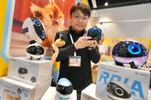 Kevin Koo showcases his company’s companion robots at the expo. Photo: Karma Lo