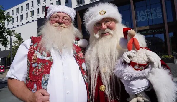 Robert Hercz, a 64-year-old Santa Claus performer with another Santa performer.