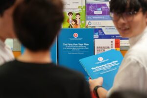 People collect copies of the consultation document for Hong Kong’s first five-year blueprint at the Wan Chai district Office on June 15. Photo: Karma Lo
