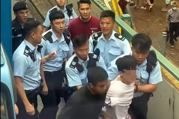 Officers lead away the driver after a high-speed chase across Hong Kong Island. Photo: Handout