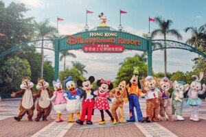 Disney characters pose at Hong Kong Disneyland entrance gate.