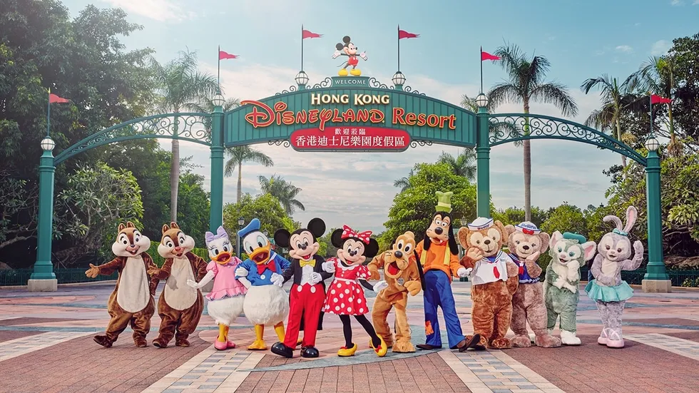 Disney characters pose at Hong Kong Disneyland entrance gate.