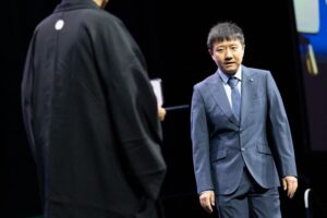 Mathematician Deng Yu walks onstage as he is awarded the 2026 Fields Medal during the International Congress of Mathematicians in Philadelphia on Thursday.