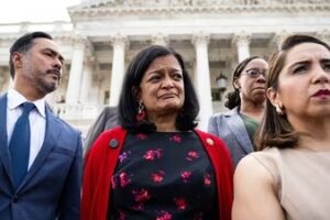 Rep. Pramila Jayapal (D., Wash.), in red, with members of the Congressional Progressive Caucus at the U.S. Capitol.