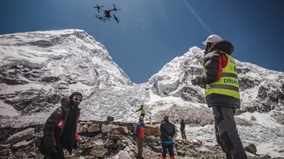 An operator uses a heavy-lift drone to clear trash from the Everest base camp.