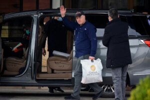 Peter Daszak waving as he leaves a hotel in Wuhan, Hubei province, China.